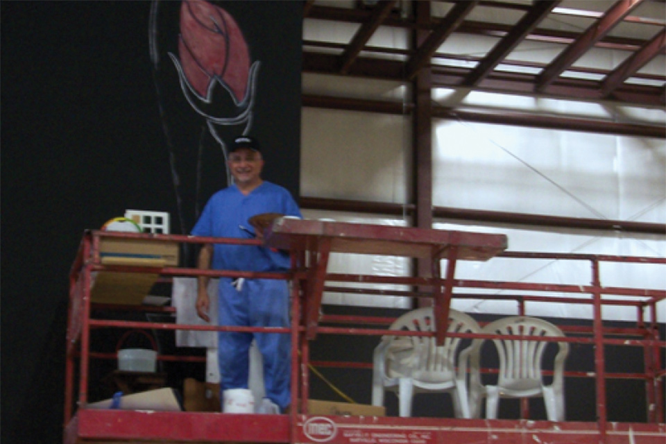 a volunteer on a scaffold working inside the Effingham Performance Center